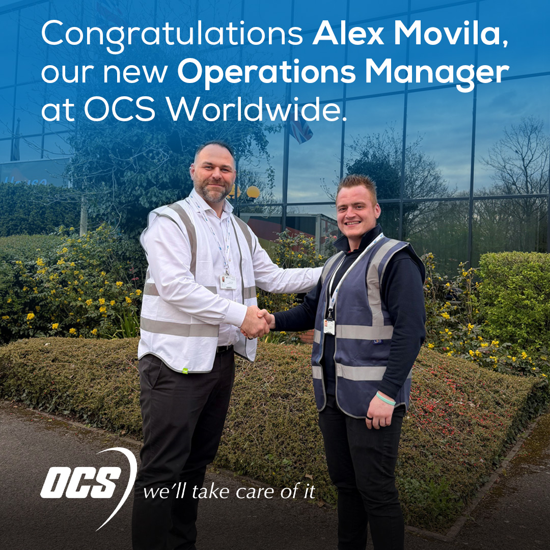 Alex Movila shakes hands with Operations Director Roberto Cinti outside the offices of OCS Worldwide, Heathrow Building.
